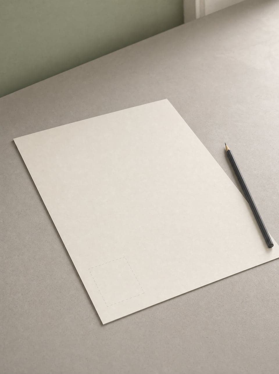 A blank sheet of drafting paper on a plain desk with a pencil beside it and one faint dashed rectangle sketched in the corner